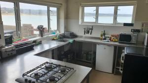 a kitchen with a stove and a counter top at YHA Port Eynon in Port-Eynon