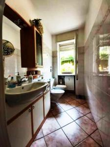 a bathroom with a sink and a toilet at Casa Lù in Abbadia Lariana