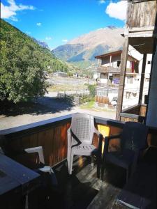 a balcony with a table and chairs and a mountain at Salome Guest House in Mestia