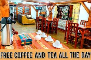 a living room with a table with coffee and teas on it at Hotel Maderanegra By Huasicama in Latacunga