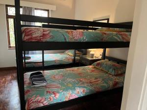 a room with three bunk beds in a room at 10 st Johns - House in Port Shepstone