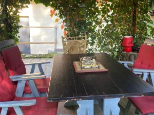 a wooden table with two chairs and a book on it at Agroturystyka Staroscin in Rzepin