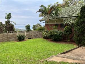 a house with a fence and a yard at 10 st Johns - House in Port Shepstone