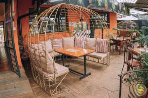 a room with a table and chairs in a bird cage at Sochati Casa Resort in Nairobi