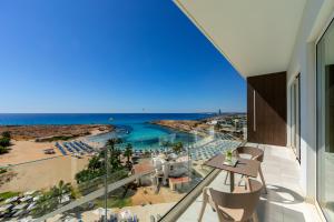 a view of the beach from the balcony of a hotel at Chrysomare Beach Hotel & Resort in Ayia Napa