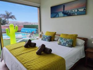 a bedroom with a bed with a yellow comforter at Villa Lía by SunHousesCanarias in Salobre +24 photos