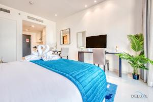 a bedroom with a bed with two swans on it at Peaceful Studio at Celestia A Dubai South by Deluxe Holiday Homes in Dubai