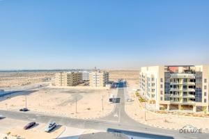 an aerial view of a city with buildings and a street at Peaceful Studio at Celestia A Dubai South by Deluxe Holiday Homes in Dubai