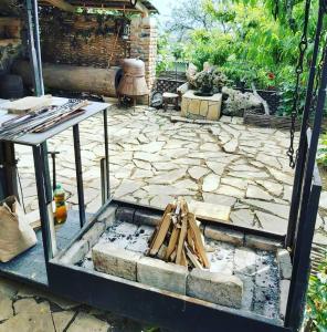 a stone patio with a table and tools on it at Safari House Tbilisi Wine & Family Hotel in Tbilisi City
