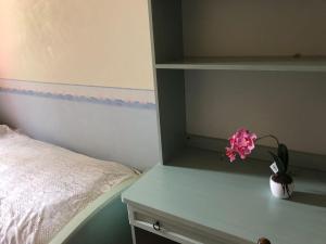 ein Schlafzimmer mit einem Bett und einem Tisch mit einer Blumenvase in der Unterkunft Villa Filippa in Nicosia
