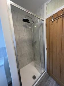 a shower with a glass door in a bathroom at Midland road studio in Wellingborough