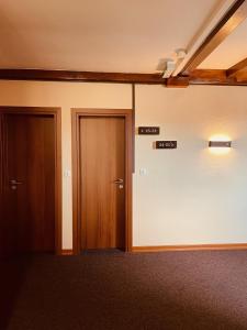 an empty room with two doors in a building at Hotel Residenz in Ansbach