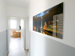 a hallway with a painting hanging on a wall at Hotel St. Peter in Dormagen