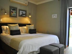 a bedroom with a large bed in a room at Christie's Inn in Tzaneen