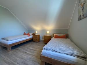 a room with two beds and two night stands at Hotel St. Peter in Dormagen