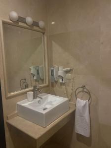 a bathroom with a white sink and a mirror at Hostal Tres Soles in Nerja