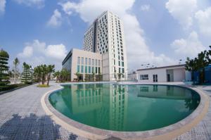 a swimming pool in front of a building at Muong Thanh Grand Thanh Hoa Hotel in Thanh Hóa