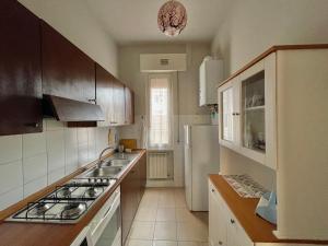 a kitchen with a stove and a white refrigerator at Santo Spirito in Arezzo
