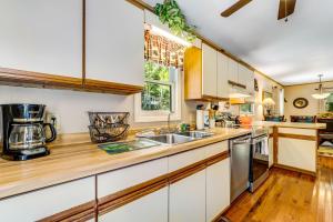 a kitchen with white cabinets and a wooden counter top at Grandfather's Gem Getaway in Banner Elk