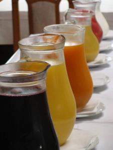 a row of jars of orange juice on a table at Frühstückspension Steffi in Sankt Kanzian