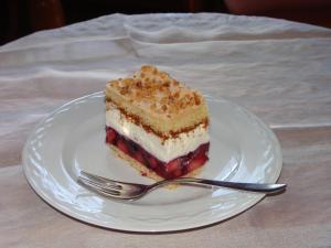 a piece of cake on a white plate with a fork at Frühstückspension Steffi in Sankt Kanzian