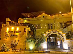 a building with a sign that reads peaceley square at night at Rose Valley Hotel in Göreme