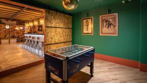 a room with a pinball machine in front of a wall at Villa Saint Exupery Beach Hostel in Nice
