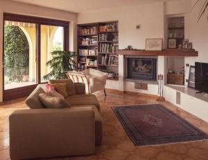 a living room with a couch and a fireplace at Amazing 3 bedrooms villa with lavish garden, breathtaking lake and mountains view in Luino