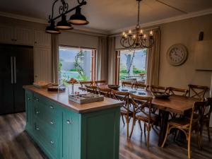 a kitchen and dining room with a table and chairs at Bontebokskloof Manor in Swellendam