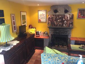 a living room with a fireplace and a desk at Nel verde house di Rolando in Turin