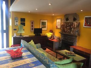 a living room with a couch and a fireplace at Nel verde house di Rolando in Turin