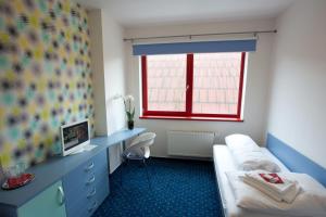 Giường trong phòng chung tại Hotel Galaxie