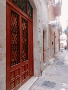 a red door on the side of a building at JASMINE HOUSE in Triggiano