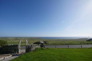 a view of the ocean from the top of a hill at Macleod Cottage - Isle of Lewis Self-Catering in Port of Ness