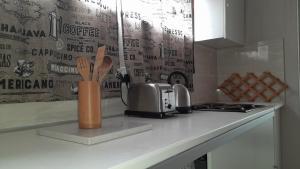 a kitchen counter with a counter top with a knife and fork at Limbila House in Cape Town