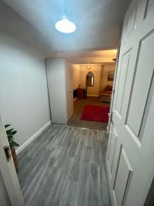 an empty room with a door and a living room at Y Teifi in Llandysul