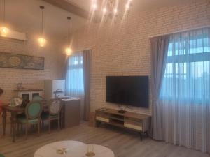 a living room with a television and a brick wall at 宜蘭五結羅東 田中268 in Yilan City