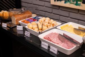 a display case with different types of food on at Premier Hotel in Votuporanga