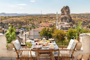 a table with food on top of a balcony at Oba Cave Hotel in Urgup