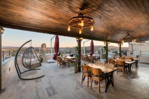 a restaurant with tables and chairs and a large window at Oba Cave Hotel in Urgup