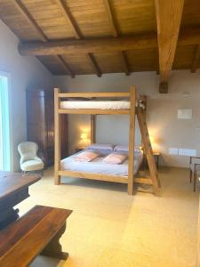 a bedroom with a bunk bed with a wooden ceiling at Rio Sabbioso in Dozza