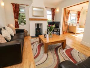 a living room with a couch and a coffee table at Orchard Cottage in Ashbourne