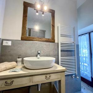 a bathroom with a sink and a mirror at Rifugio Baita Gimont in Cesana Torinese