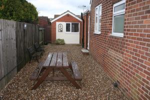 a picnic table in a courtyard next to a brick building at Twin Bays in Hedon