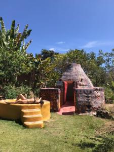 a person laying on a couch next to a brick oven at Sítio Monte Alegre in Ibicoara