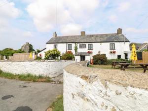 a white house with a picnic table in front of it at Trefechan - 4 Plough & Harrow in Cowbridge