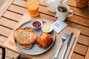 a plate of breakfast food on a wooden table at Sonder DO Plaça Reial in Barcelona