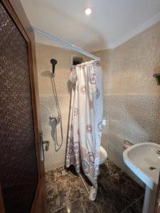 a bathroom with a shower curtain and a sink at Riad Elijah Marrakech & Spa in Marrakech