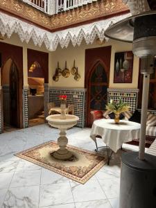 a living room with a sink and a table at Riad Elijah Marrakech & Spa in Marrakech