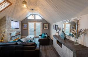 a living room with a couch and a fireplace at Lakeland Lodge in Carnforth